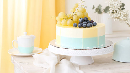 Soft pastel photo of layered cake dessert with yellow frosting, a sweet baked treat radiating warmth, faith, and joyful celebration.の素材