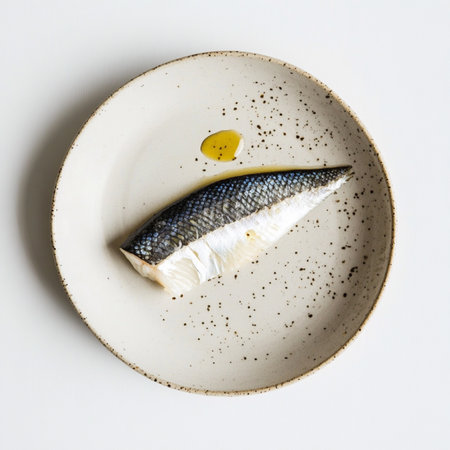 Seafood fillet on simple contemporary plate, top-down view, fresh protein, gourmet cuisine image.の素材