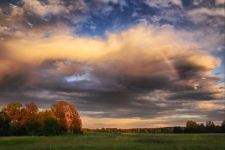 Evening landscape with rainbowの写真素材