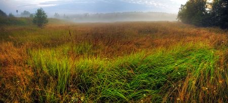 Panoramic landscape with field and fog in the eveningの写真素材