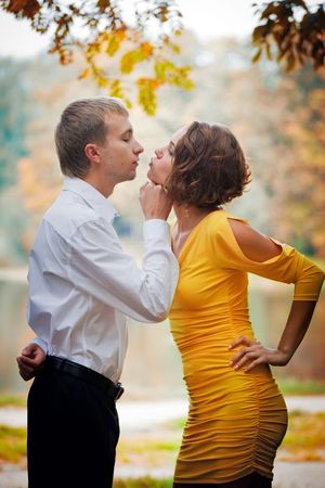 Young couple on date in an autumn parkの写真素材