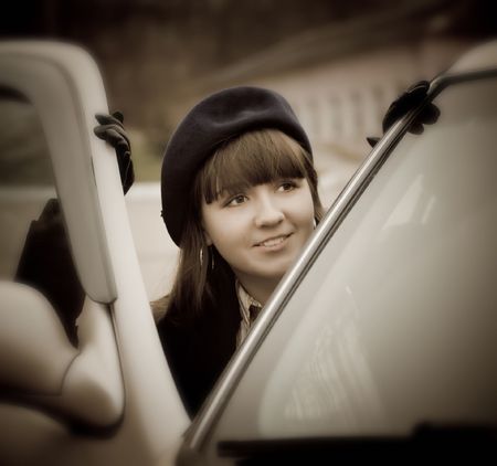 Young woman in a retro car, vintage styleの写真素材