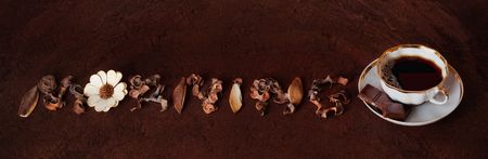 The cup of coffee with chocolate on brown backgroundの写真素材