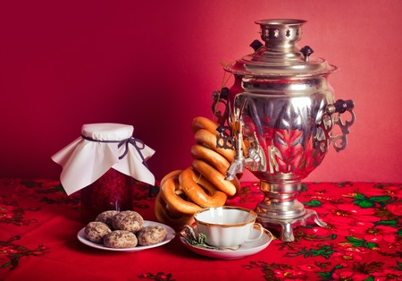 Traditional Russian tea from Samovar with cakes, bagels and raspberry jamの写真素材