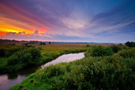 Summer landscape with river at sunsetの写真素材