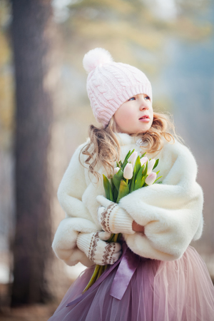 Beautiful girl with tulips  in spring parkの写真素材