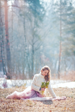 Beautiful walking woman in a spring parkの写真素材