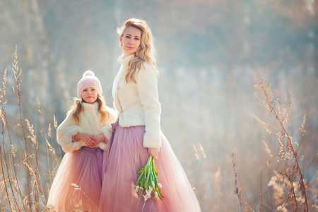 Beautiful mother with daughter in spring parkの写真素材