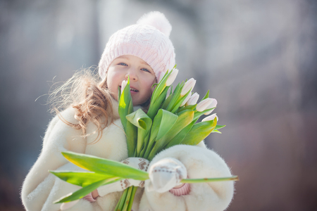 Beautiful girl with tulips  in spring parkの写真素材