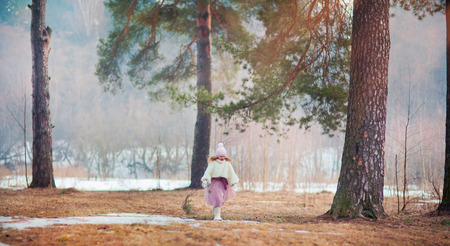 Beautiful little girl in early  spring parkの写真素材