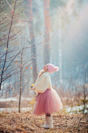 Beautiful little girl in early  spring parkの写真素材