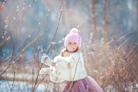 Beautiful little girl in early  spring parkの写真素材