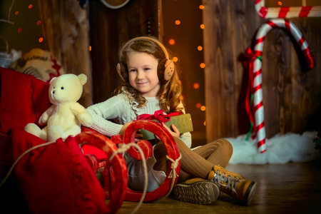 Little girl with her Maltese dog at Christmas Eveの写真素材