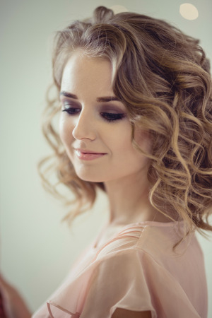 Studio Portrait of pretty woman with curly hair in 30-th years styleの写真素材