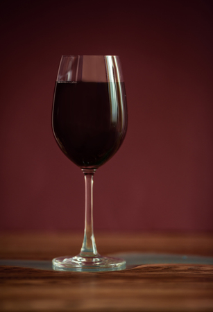 Alcohol drinks (red wine, whisky, grapefruit cocktail) on dark solid red backgroundの写真素材