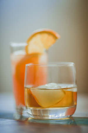 Alcohol drinks (red wine, whisky, grapefruit cocktail) on light backgroundの写真素材