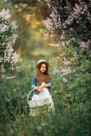 Little sisters outdoor portrait near lilac tree at spring eveningの写真素材