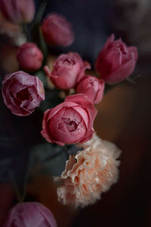 Bouquet of beautiful flowers with purple peony roses, carnations and tulips, in the craft paperの写真素材