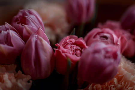 Bouquet of beautiful flowers with purple peony roses, carnations and tulips, in the craft paperの写真素材