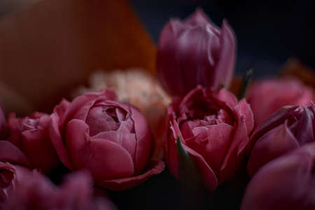 Bouquet of beautiful flowers with purple peony roses, carnations and tulips, in the craft paperの写真素材