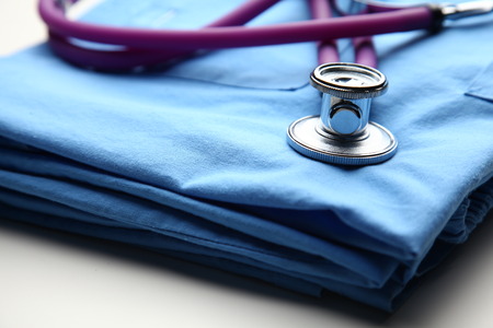 Doctor coat with stethoscope on the desk .の写真素材