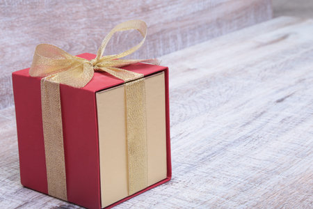 Gift boxes with bow on wood background.