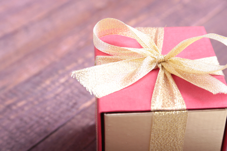 Gift boxes with bow on wood background.の写真素材