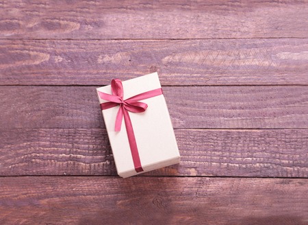 Gift boxes with bow on wood backgroundの写真素材