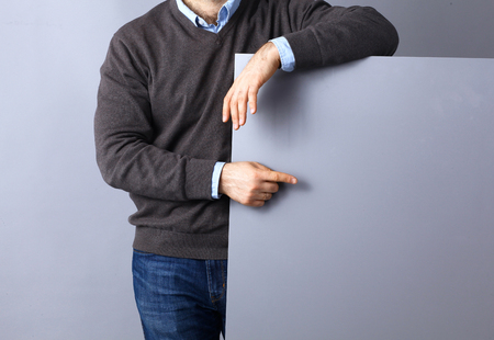 Businessman holding a blank board , pointing somethingの写真素材