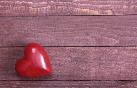 Beautiful red heart isolated on wooden backgroundの写真素材
