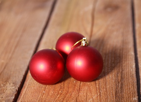 Red christmas balls on a wooden backgroundの写真素材