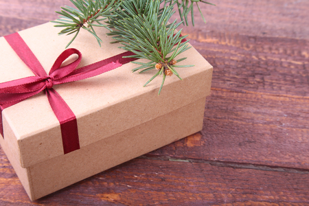 Christmas decoration fir tree with gift box and many balls, on wooden boardの写真素材