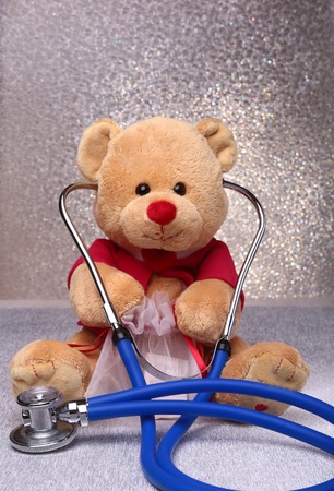 Teddy bear and stethoscope on a white backgroundの写真素材