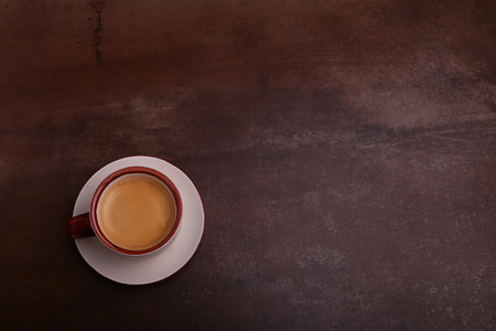 A cup of espresso coffee on a dark wooden backgroundの写真素材