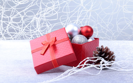 Gift boxes with bow and christmas balls on wood background. Decoration