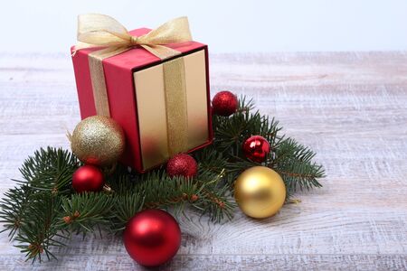 Christmas fir tree with gift box on wooden board.の写真素材