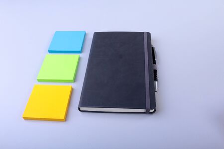 Top view of blank notebook and empty note sticker on a blue background. Back to school concept. Flat lay.の写真素材