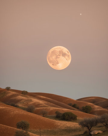 AI Generated. Golden Full Moon Illuminating a Warm Earthy Landscapeの素材