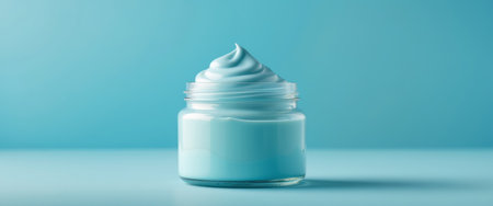 AI Generated. Smooth Blue Cream in a Glass Jar on a Turquoise Backgroundの素材