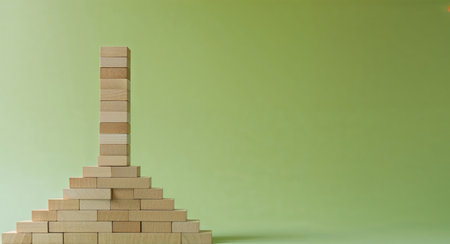 AI Generated. Wooden block tower on green background representing project management and resource efficiencyの素材