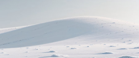 AI Generated. A white snow covered hill with a few small snow patchesの素材