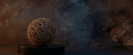 An abstract art photograph featuring a woven sphere on a pedestal, set against a blurred, dark background with smoky, moody lighting artistic and contemplative.の素材