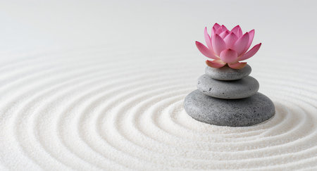 Serene Zen garden featuring a delicate pink lotus flower atop a carefully balanced stone cairn, set in raked white sand. Perfect for relaxation and meditation practices.の素材