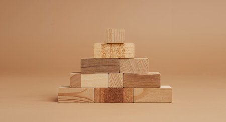 This image showcases a pyramid of wooden blocks, symbolizing stability and growth. Its simple design evokes a sense of calm and potential for building something great.の素材
