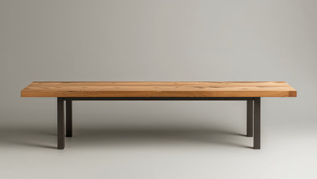 A wooden surface with a distinct grain pattern sits atop simple metal legs. Soft lighting highlights the textures of wood and metal against the gray background.の素材