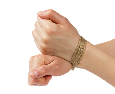 woman hands bound by rope or string isolated on white backgroundの写真素材