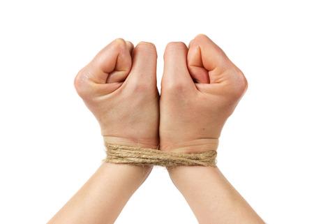 woman hands bound by rope or string isolated on white backgroundの写真素材