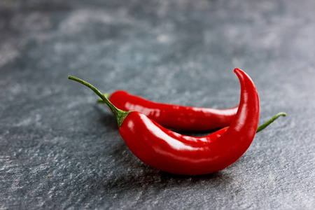 chili pepper on a black stone background, selective focusの写真素材