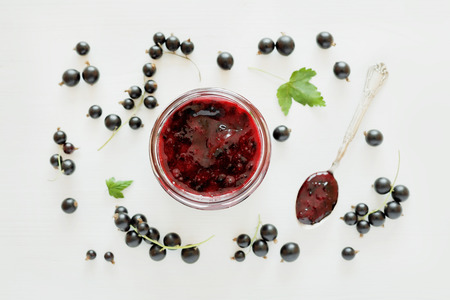 Blackcurrant jam in jar on white background, top viewの写真素材