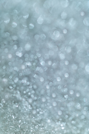 winter snow background with magic bokeh effect, glitter abstract festive backgroundの写真素材